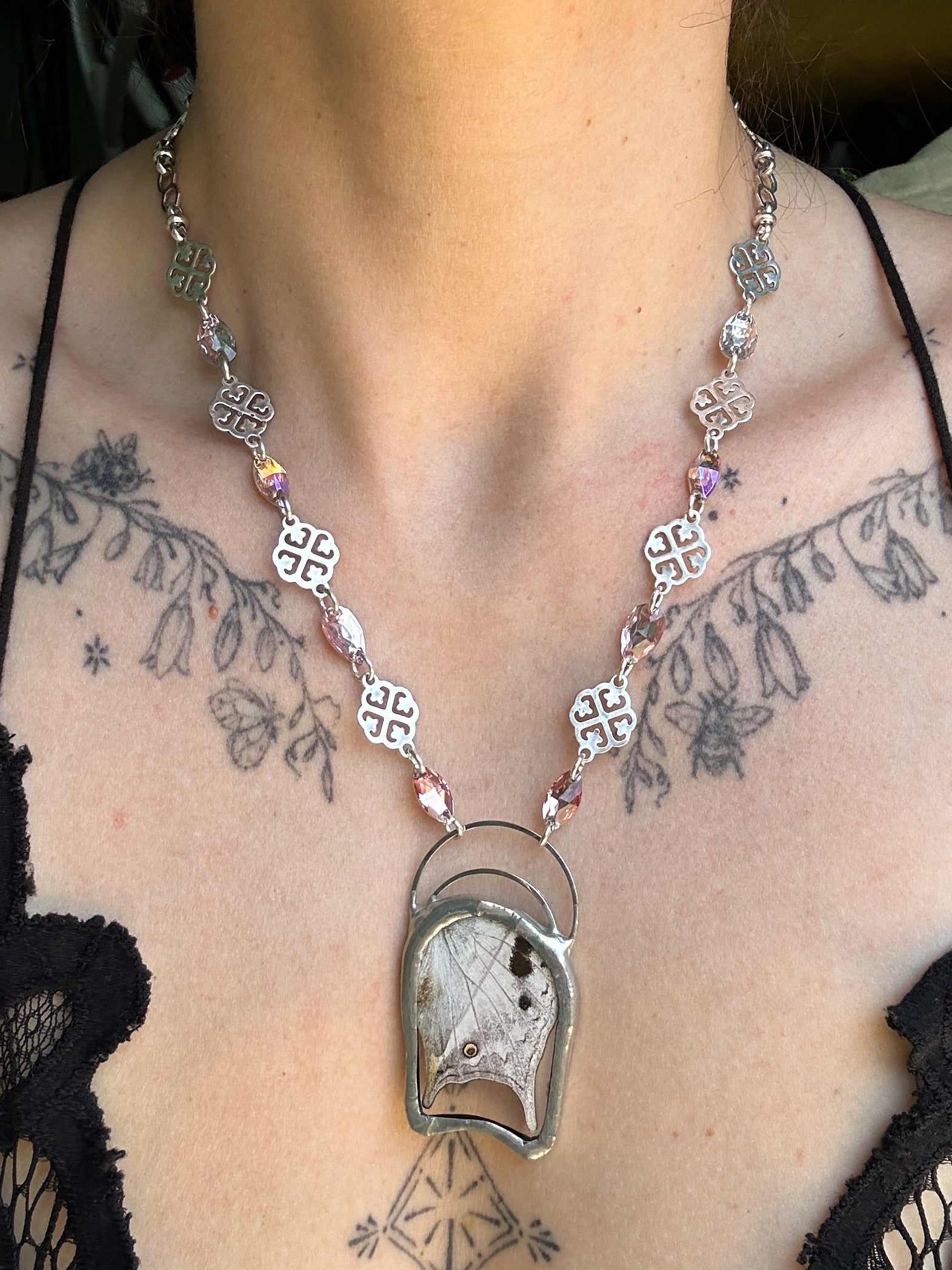 Butterfly Necklace with a pendant worn by a person with tattoos on their neck.